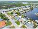 Aerial view of the home in a waterfront community, showcasing its proximity to the water and other homes at 12535 Third Isle, Hudson, FL 34667