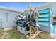 Backyard with an outdoor storage setup and blue louvered windows at 12535 Third Isle, Hudson, FL 34667