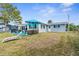 Exterior view of the backyard featuring patio furniture, landscaping and the canal at 12535 Third Isle, Hudson, FL 34667