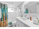 Bathroom with a shower-tub combo, a bright surfboard-themed shower curtain, and vanity at 12535 Third Isle, Hudson, FL 34667