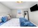 Bedroom featuring white furniture, blue accents, and a mounted television at 12535 Third Isle, Hudson, FL 34667