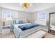 Bedroom featuring white furniture, two windows, and ceiling fan light fixture at 12535 Third Isle, Hudson, FL 34667