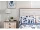 Comfortable bedroom featuring nautical themed decor, with a wood nightstand and lamp at 12535 Third Isle, Hudson, FL 34667