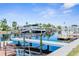 Private boat dock with a boat lift, offering convenient access to the waterfront and boating activities at 12535 Third Isle, Hudson, FL 34667