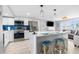 Bright open kitchen with modern appliances, white cabinetry, and a breakfast bar with seating at 12535 Third Isle, Hudson, FL 34667