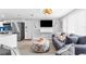 Inviting living room with gray sofas and a view into the kitchen at 12535 Third Isle, Hudson, FL 34667