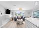 Open-concept living room featuring wood floors and modern décor at 12535 Third Isle, Hudson, FL 34667