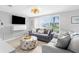 Bright living room with a large window and comfortable seating at 12535 Third Isle, Hudson, FL 34667