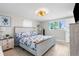Comfortable main bedroom with a decorative bedding, ceiling fan and natural light from the windows at 12535 Third Isle, Hudson, FL 34667