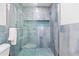 Stylish glass enclosed shower with tiled walls, a pebble floor, and a built-in niche at 12535 Third Isle, Hudson, FL 34667