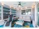 Cozy sunroom with comfortable seating, a ceiling fan, and string lights at 12535 Third Isle, Hudson, FL 34667