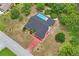 This home features a pool and landscaping in an aerial view with trees around it at 128 Oak Lake Dr, Spring Hill, FL 34608