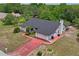 Aerial view of the home showing the landscaping, garage, and neighborhood setting at 128 Oak Lake Dr, Spring Hill, FL 34608