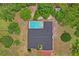 Aerial view of house showcasing a screened in pool and the surrounding mature landscaping at 128 Oak Lake Dr, Spring Hill, FL 34608