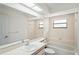 Classic bathroom features a large mirror, built-in bathtub, and plenty of natural light at 128 Oak Lake Dr, Spring Hill, FL 34608