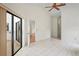 Spacious tile bedroom featuring sliding glass doors and backyard access at 128 Oak Lake Dr, Spring Hill, FL 34608