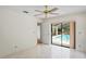 Neutral bedroom with pool view features neutral tile flooring and a ceiling fan at 128 Oak Lake Dr, Spring Hill, FL 34608
