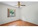 Neutral bedroom with window features hardwood flooring and natural light at 128 Oak Lake Dr, Spring Hill, FL 34608