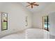 Bedroom showcasing tile floors, natural light, and sliding glass door to the pool at 128 Oak Lake Dr, Spring Hill, FL 34608