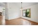 Dining room with wood floors, a light fixture, a large window, and views of the backyard at 128 Oak Lake Dr, Spring Hill, FL 34608