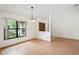 Bright dining room with hardwood floors, a window with views of the outdoors, and a chandelier at 128 Oak Lake Dr, Spring Hill, FL 34608