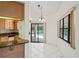 Dining room with tile floors, chandelier, breakfast bar, and sliding glass doors to the pool area at 128 Oak Lake Dr, Spring Hill, FL 34608