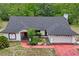 Exterior elevation featuring a two-car garage, mature landscaping and red trim at 128 Oak Lake Dr, Spring Hill, FL 34608