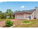 The two-car garage features plenty of storage and parking space, as well as an automatic garage door at 128 Oak Lake Dr, Spring Hill, FL 34608