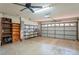 The spacious garage features shelving and an automatic garage door at 128 Oak Lake Dr, Spring Hill, FL 34608