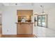 Open-concept kitchen and dining area with wood cabinets, white appliances, and access to the pool area at 128 Oak Lake Dr, Spring Hill, FL 34608