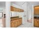 Bright kitchen features wood cabinets, granite countertops, white appliances, and white tile flooring at 128 Oak Lake Dr, Spring Hill, FL 34608