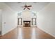 Expansive living room with vaulted ceilings, a fireplace, wood flooring, and ample natural light at 128 Oak Lake Dr, Spring Hill, FL 34608
