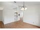 Open living space with hardwood floors, a chandelier, and views into the kitchen at 128 Oak Lake Dr, Spring Hill, FL 34608