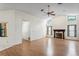 Spacious living room with high ceilings, wood floors, a fireplace, and large windows providing natural light at 128 Oak Lake Dr, Spring Hill, FL 34608