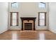 Living room with vaulted ceilings, fireplace, and large windows that provide natural light at 128 Oak Lake Dr, Spring Hill, FL 34608