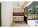Outdoor kitchen with sink, prep area and pass through to the screened pool at 128 Oak Lake Dr, Spring Hill, FL 34608