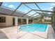 Inviting screened-in pool featuring clear blue water and ample poolside space, ideal for relaxation and enjoying the outdoors at 128 Oak Lake Dr, Spring Hill, FL 34608