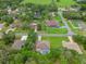 An aerial shot showing the property's location within a residential neighborhood surrounded by lush trees at 12805 Coronado Dr, Spring Hill, FL 34609