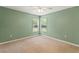 This empty green bedroom features carpet, natural light, and neutral trim at 12805 Coronado Dr, Spring Hill, FL 34609