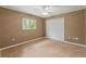 A carpeted bedroom features a ceiling fan, natural light, and a closet at 12805 Coronado Dr, Spring Hill, FL 34609