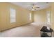Bedroom with carpet floors, ceiling fan, and neutral walls with a door leading to the pool area at 12805 Coronado Dr, Spring Hill, FL 34609