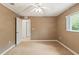 This carpeted bedroom offers a ceiling fan and a doorway to the rest of the house at 12805 Coronado Dr, Spring Hill, FL 34609