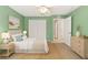 Charming bedroom with a cozy bed, ample closet space, and a soothing green color scheme at 12805 Coronado Dr, Spring Hill, FL 34609