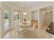Sunlit breakfast nook featuring a round table with seating for four and views of the pool at 12805 Coronado Dr, Spring Hill, FL 34609