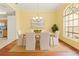 Dining room features a dining table with six chairs, a chandelier, and a large window with natural light at 12805 Coronado Dr, Spring Hill, FL 34609