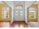 Inviting foyer featuring hardwood floors and a decorative window over the double front doors at 12805 Coronado Dr, Spring Hill, FL 34609