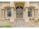 Elegant front entrance with decorative columns and a custom-designed double-door entry at 12805 Coronado Dr, Spring Hill, FL 34609