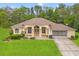 Charming single-story home boasting a well-manicured lawn, mature landscaping, and a welcoming facade at 12805 Coronado Dr, Spring Hill, FL 34609