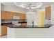 Kitchen features maple cabinets, granite countertops, white appliances, and a breakfast bar at 12805 Coronado Dr, Spring Hill, FL 34609