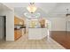 Spacious kitchen with maple cabinets, granite countertops, white appliances, and a center island at 12805 Coronado Dr, Spring Hill, FL 34609
